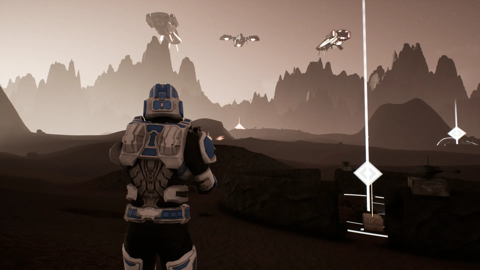 A soldier on a volcanic world under capital ships and dropships at dusk